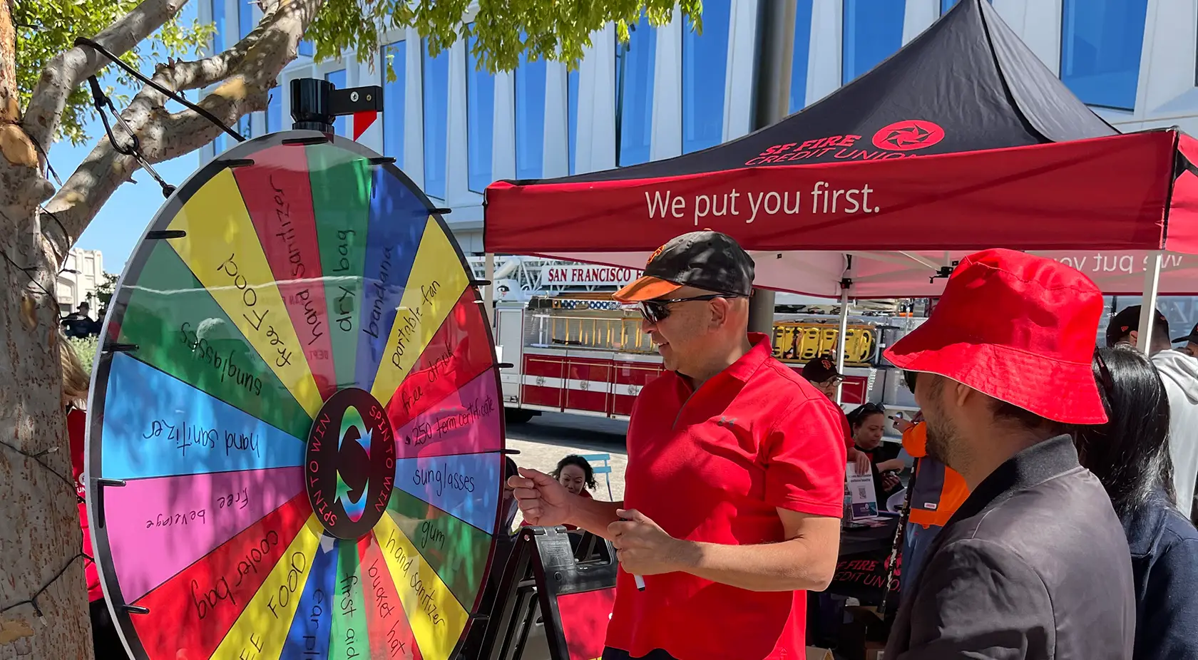Man spinning giveaway wheel at SFFire community event