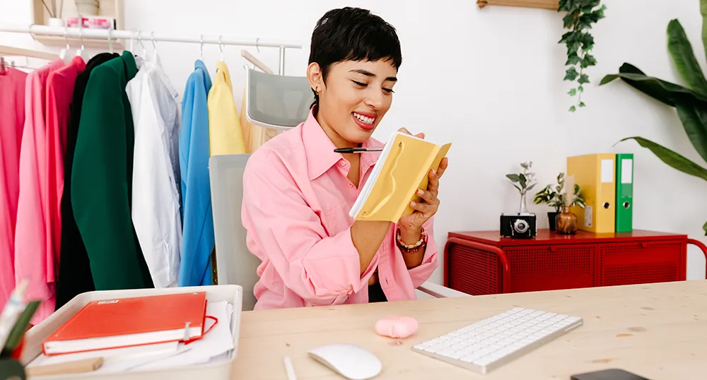 Lady in her office writing notes