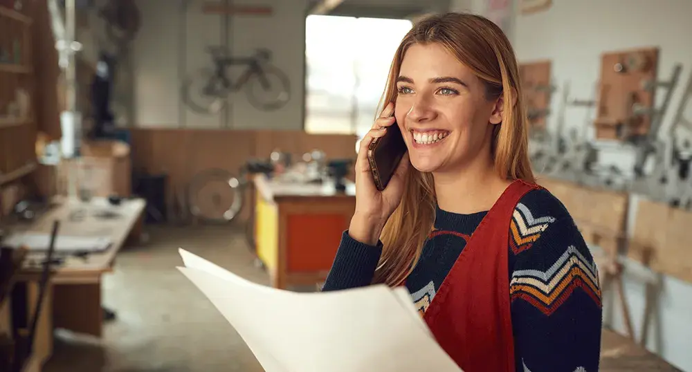 Lady on the phone reading a document