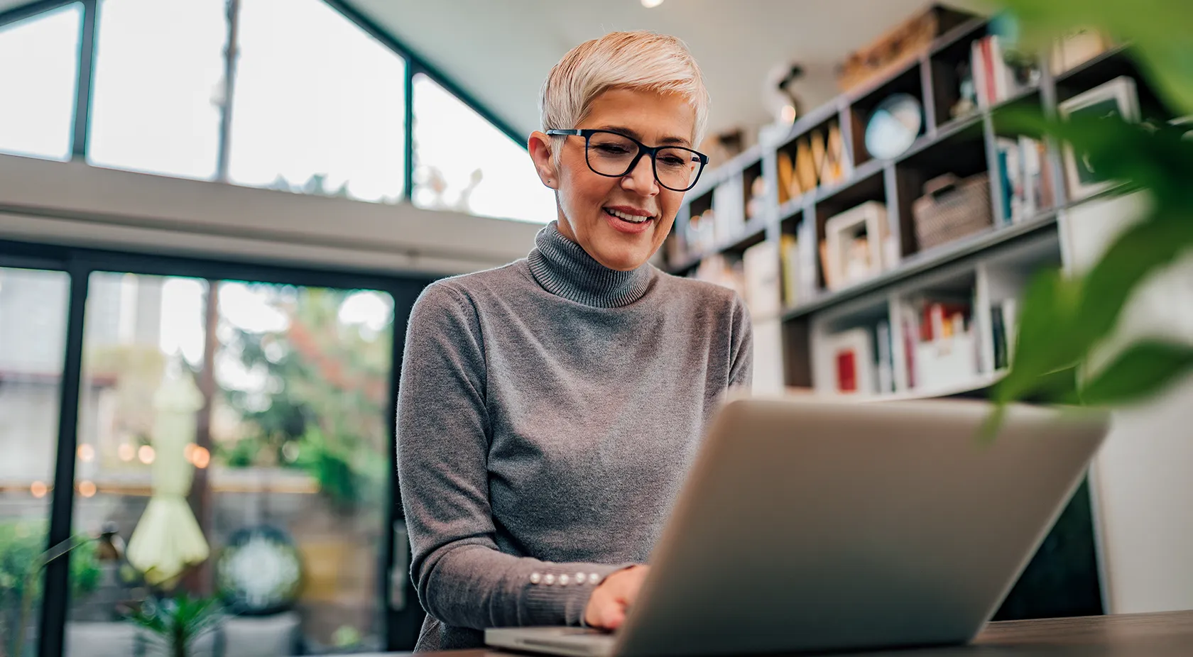 Older woman on laptop inside a building