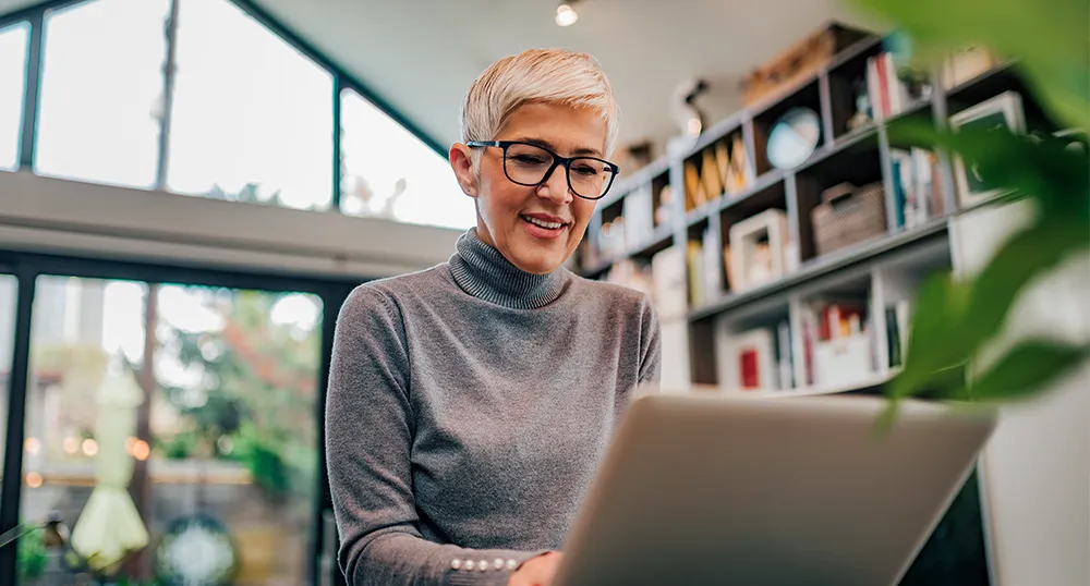 Older woman on laptop inside a building