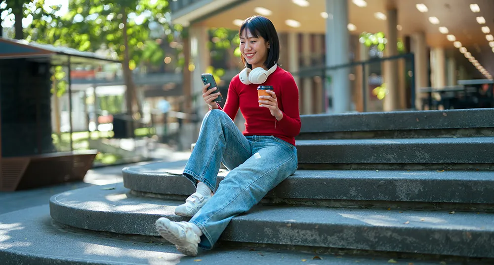 Student sitting on college steps
