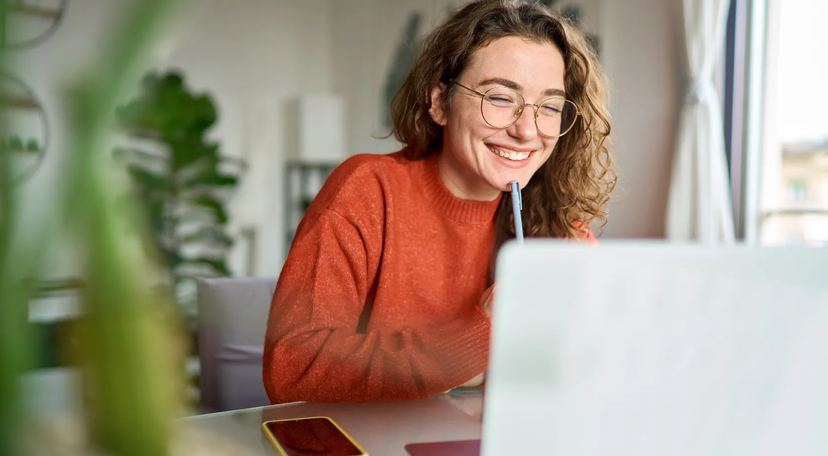Lady smiling while looking at her laptop