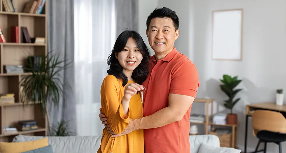 Couple standing in their new home