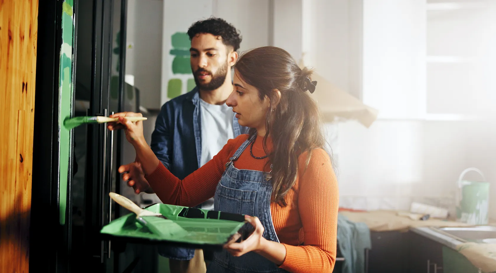 couple painting their kitchen