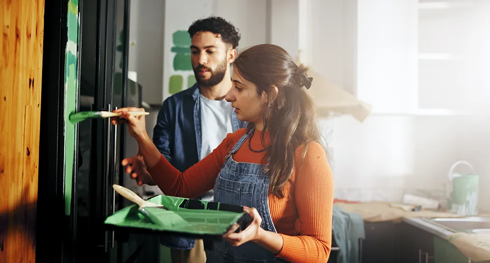 couple painting their kitchen