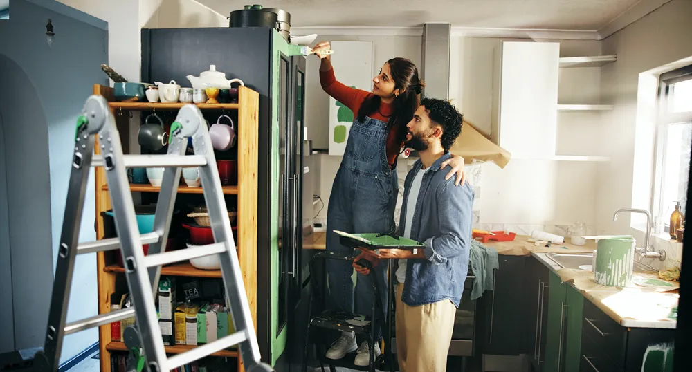 Couple paining their house