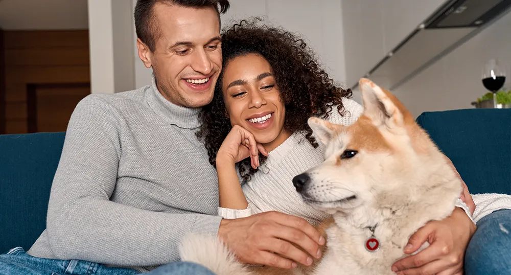 Couple on couch with their dog