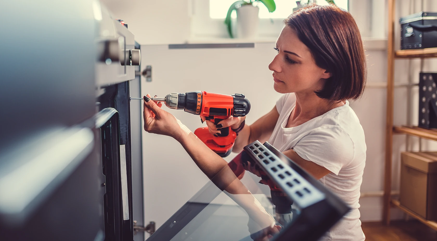 Woman fixing oven