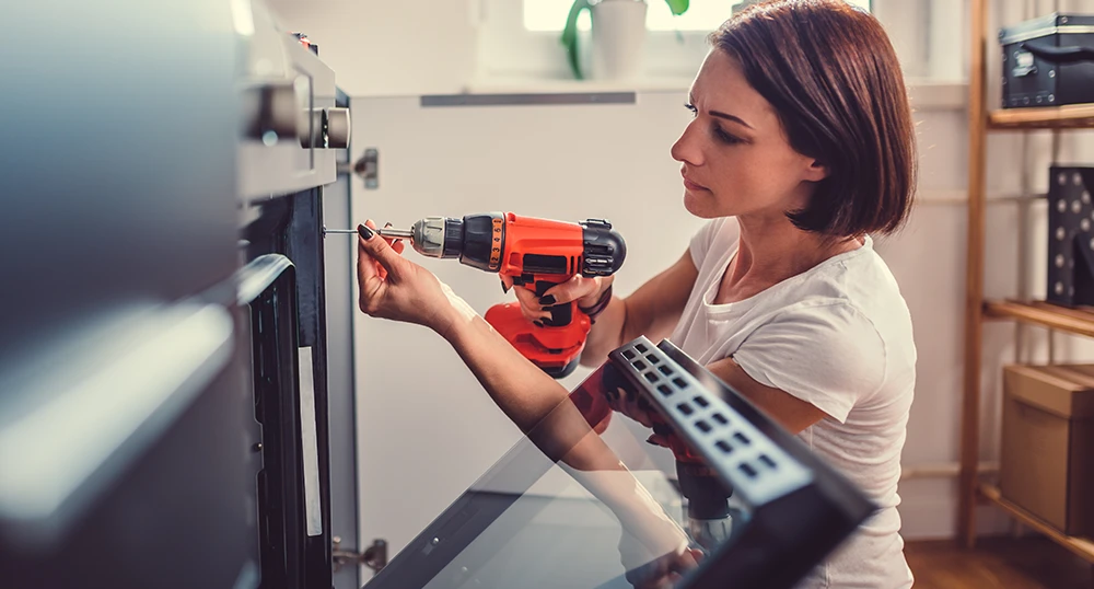 Woman fixing oven
