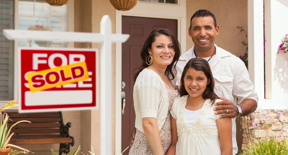 Family in front of new home