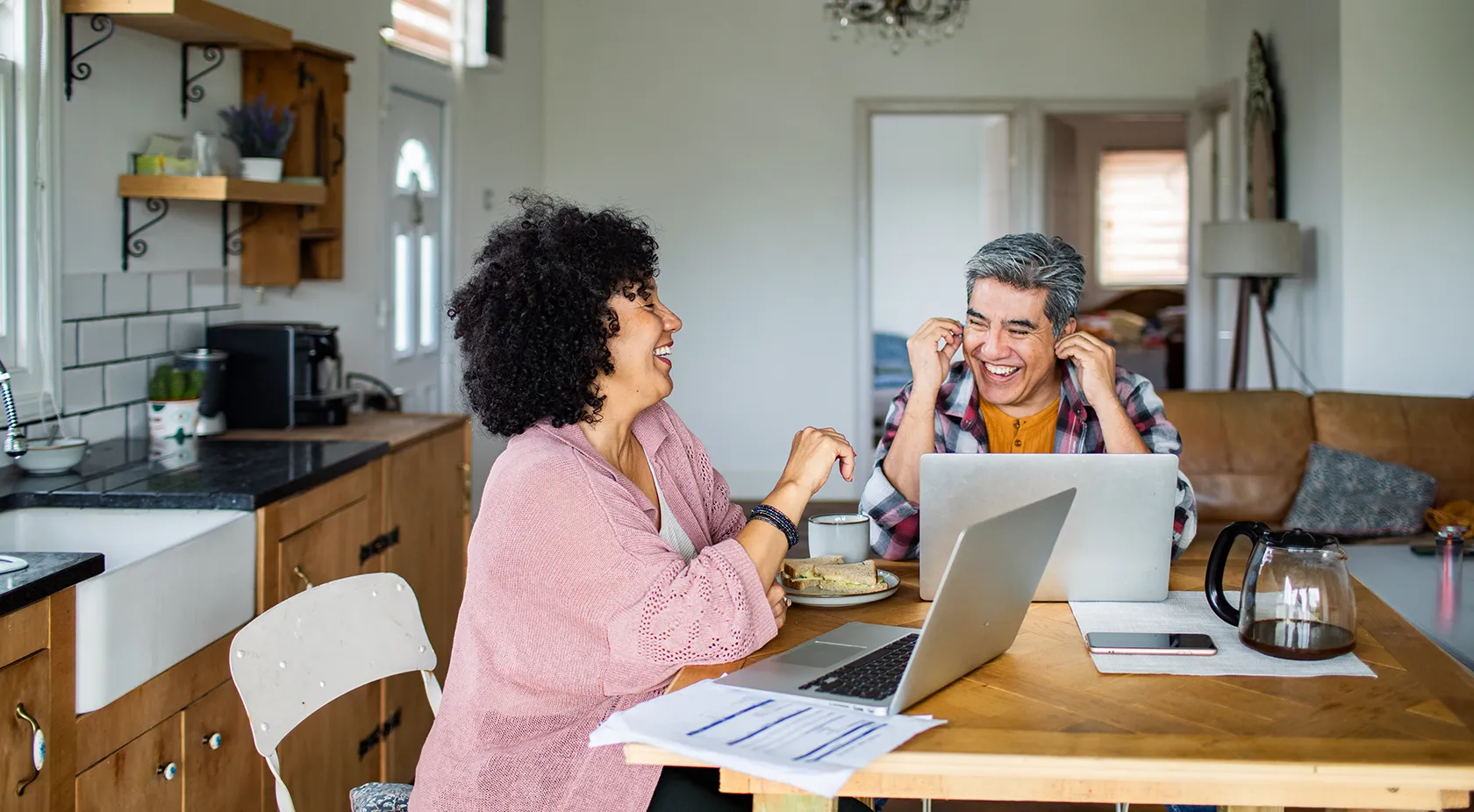 Two people on their laptops speaking to each other