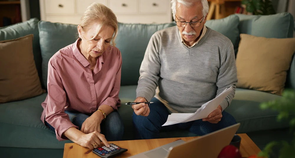 Elderly couple calculating loan