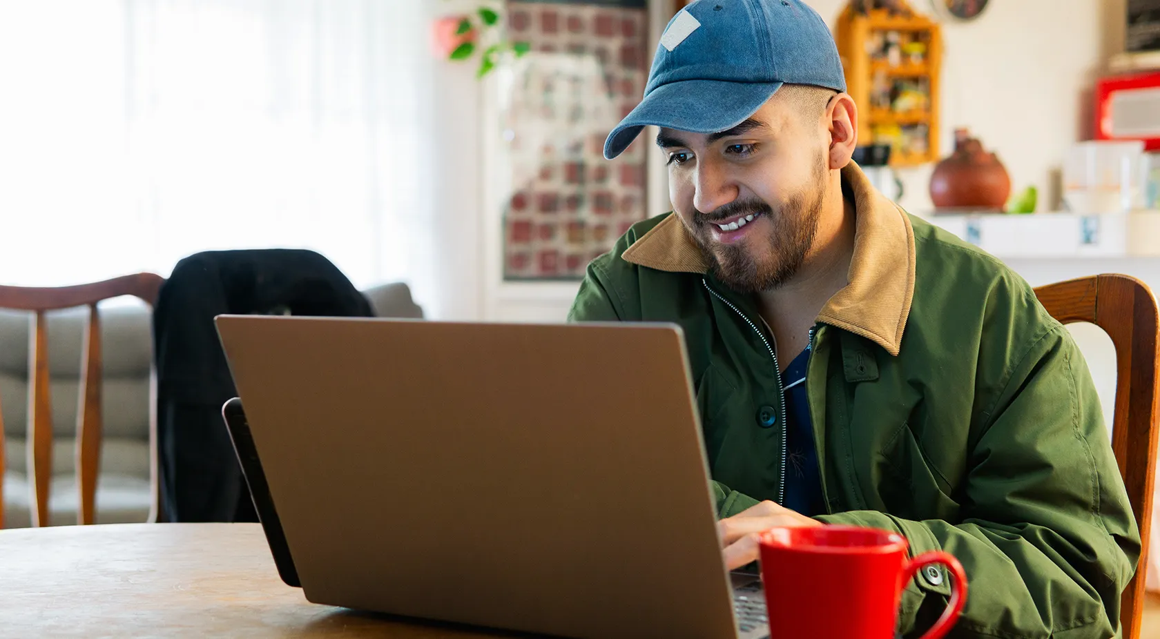 Guy sitting and looking at his laptop