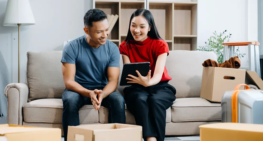 couple on couch looking at tablet