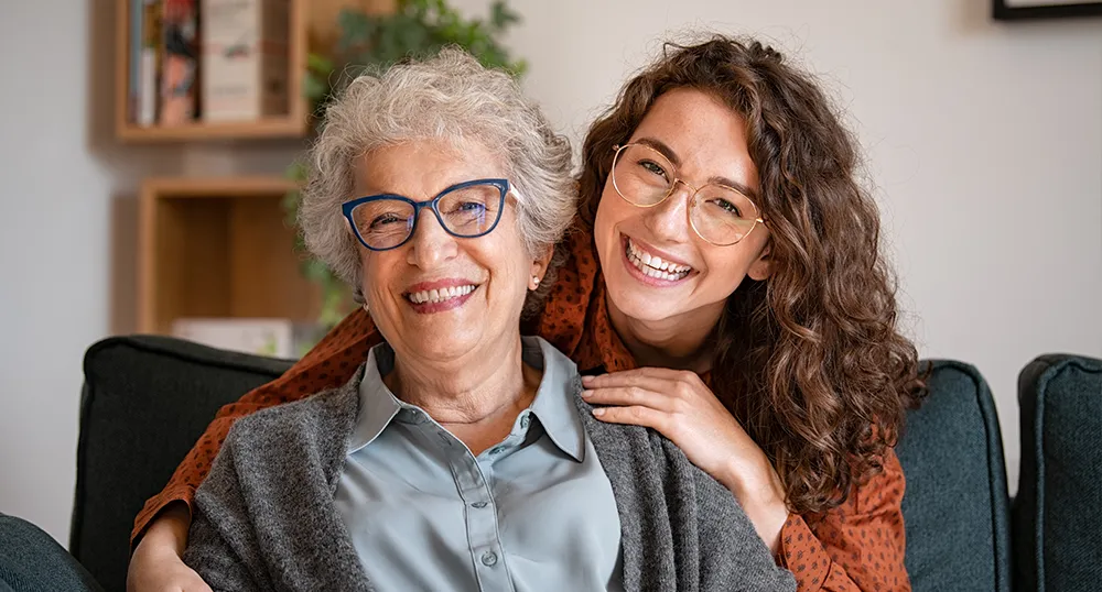 Mother and Daughter hugging and smiling