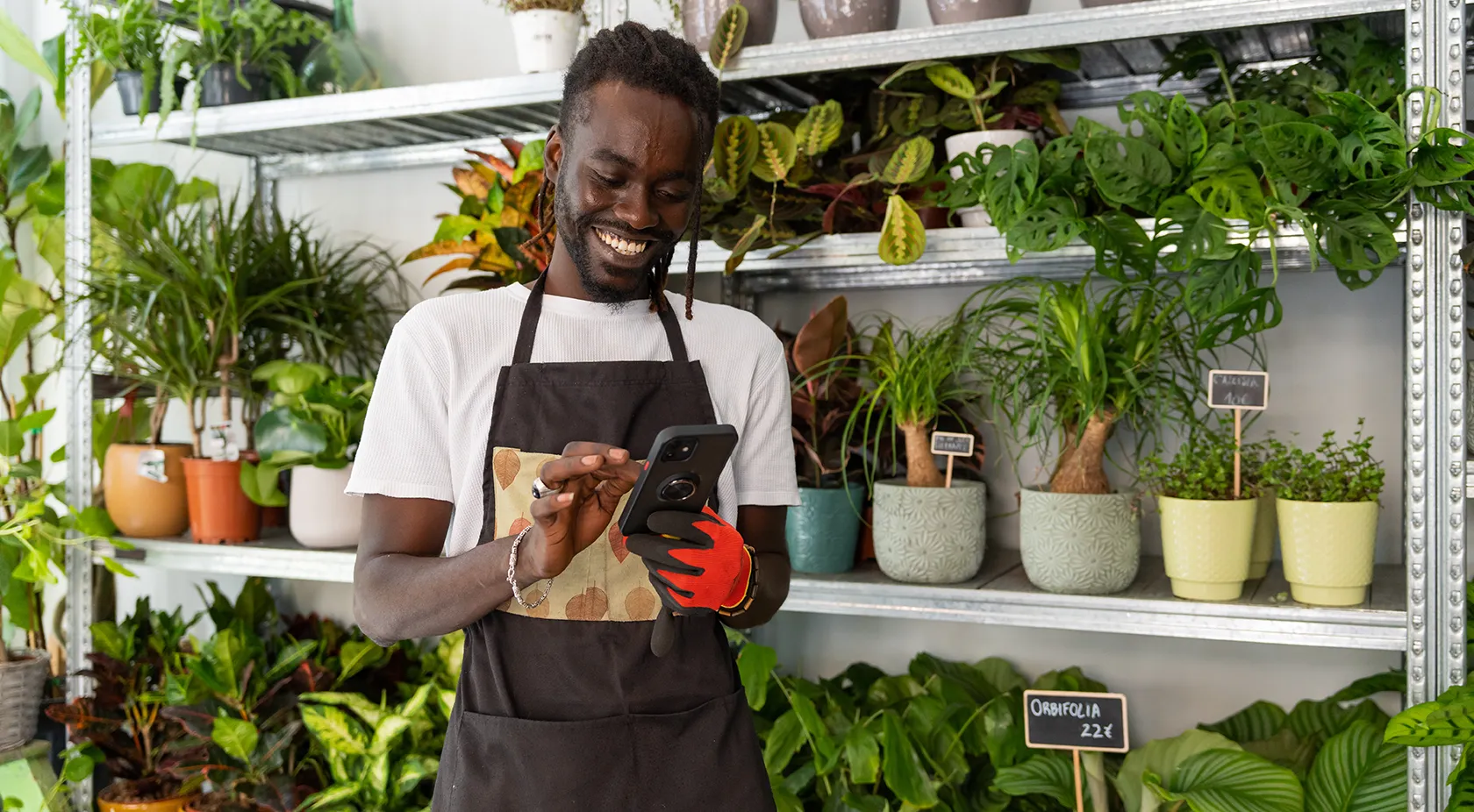 Business owner reading his phone and smiling