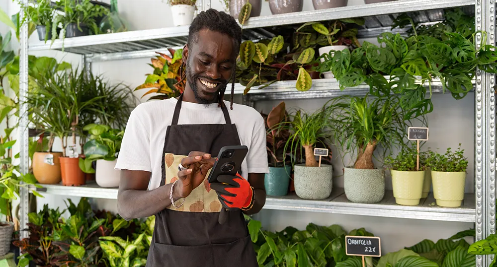Business owner reading his phone and smiling
